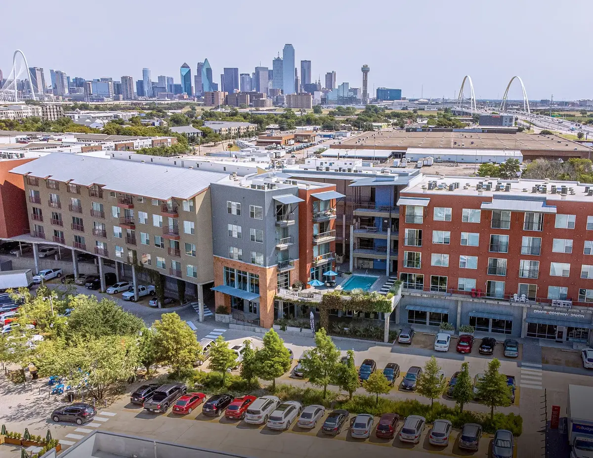 Aerial view of the Sylvan Thirty mixed-use apartment block against the Dallas skyline