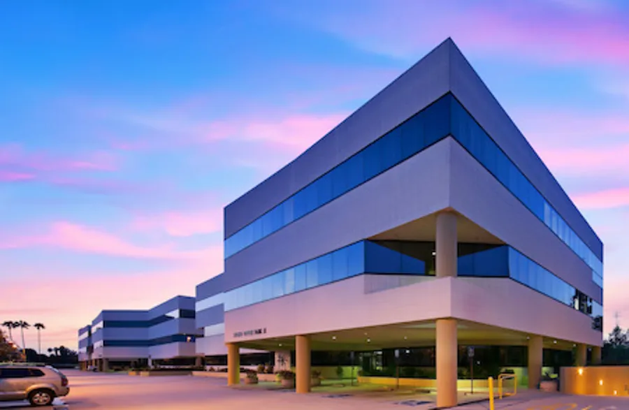Encino Office Park at dusk, a four-story office building on Balboa Boulevard
