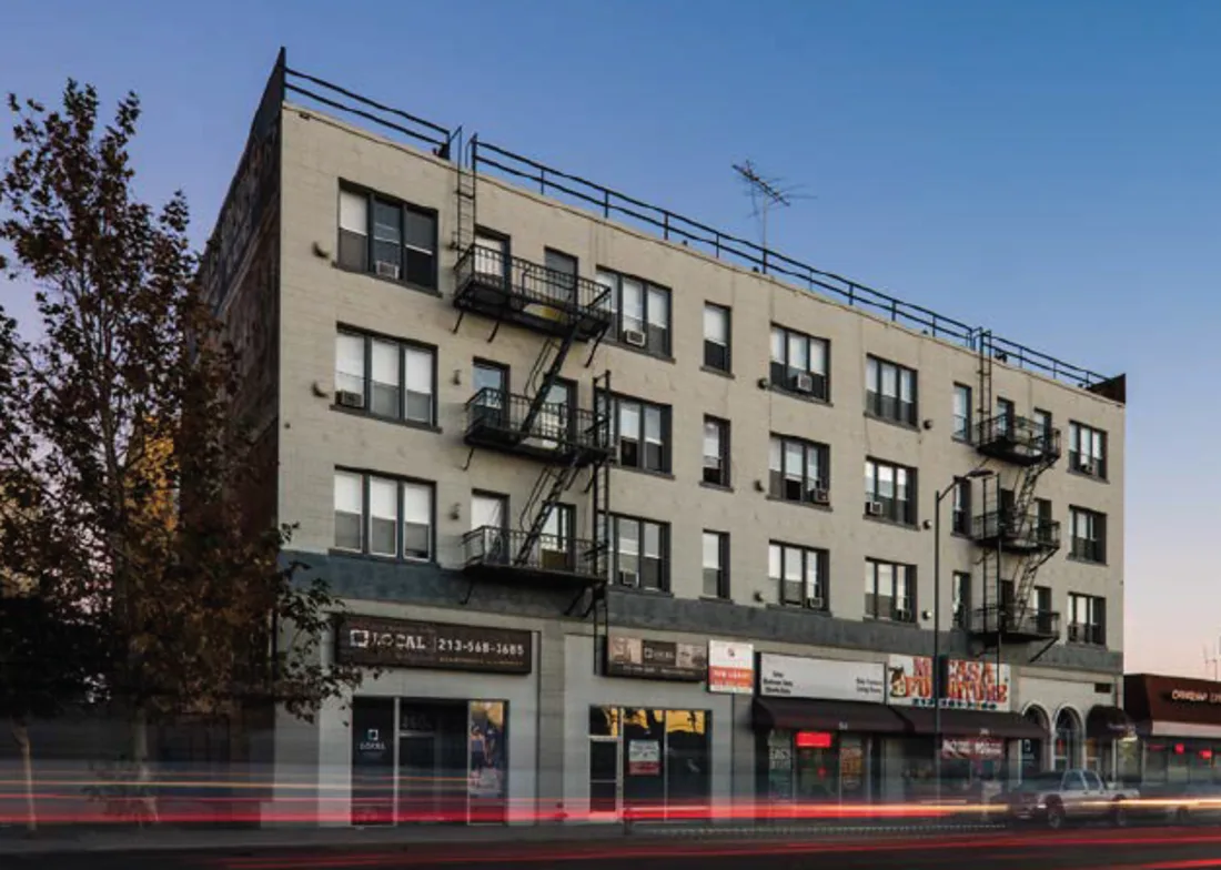 Towers on Western, a four-story brick building with ground-floor retail on Western Avenue